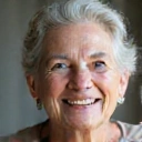 Portrait of a smiling older woman, a client of Healthy Nutrition Makassar, looking healthy and content.